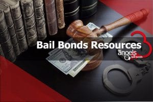 A gavel with a few dollars underneath and a pair of handcuffs beside it