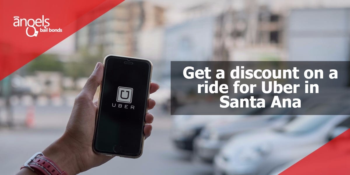 A man hand holding Uber app showing on iPhone 6s on road